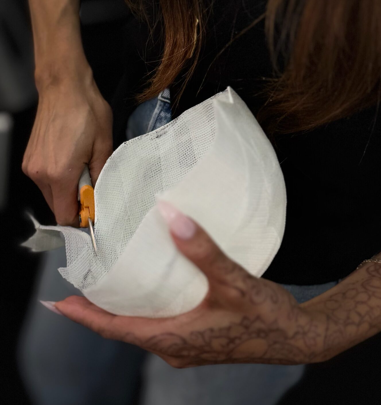 A Garnish stylist cuts a mold to size for a custom crown client