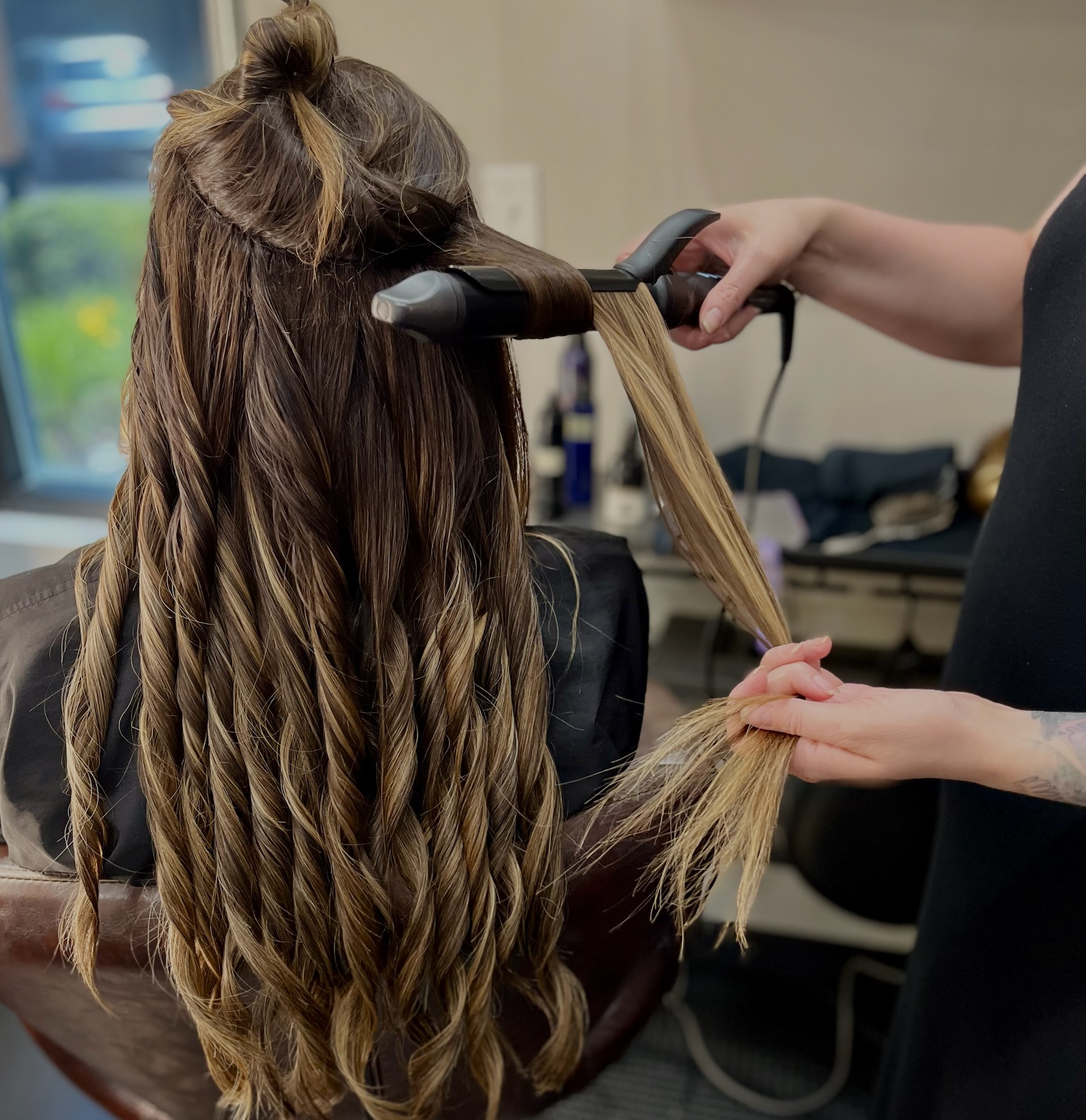 Sativa curls a guest's hair