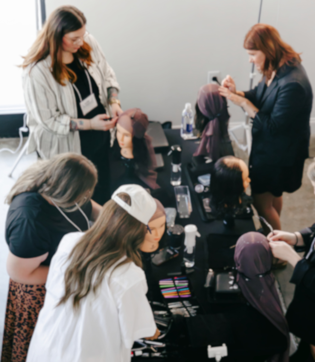 A collective of stylists and beauty industry experts work in a Garnish class