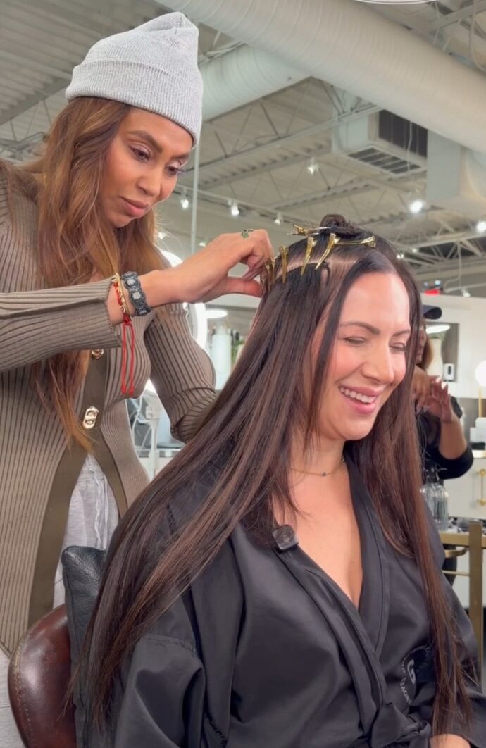 A Garnish guest laughs during a hair replacement appointment with Mot