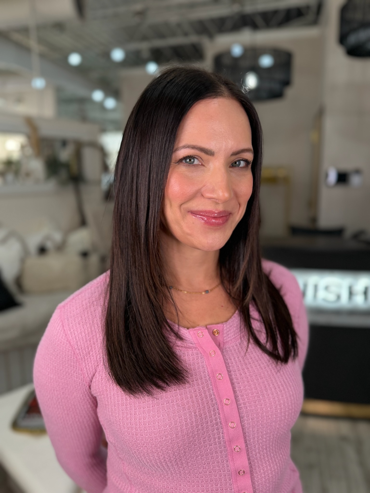 a Garnish guest smiles into the camera with her natural-looking hair pieces