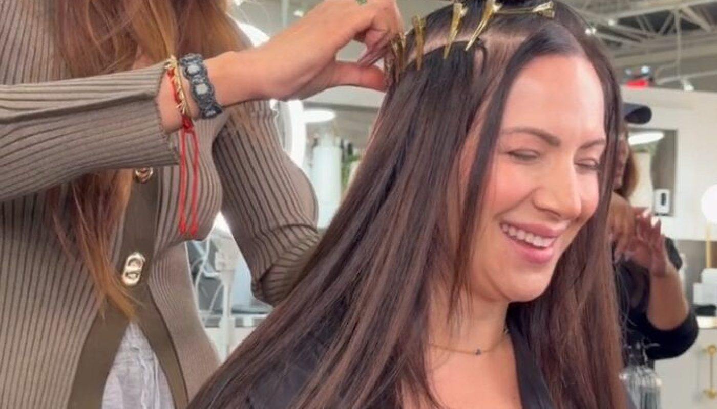 A Garnish guest laughs during a hair replacement appointment with Mot